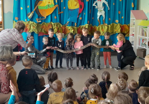 dzieci trzymają węża